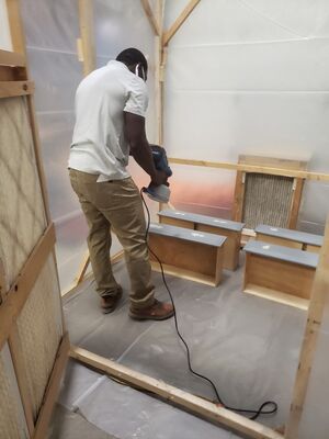 Fiifi painting his drawer fronts with an HPLV Electric Spray Gun